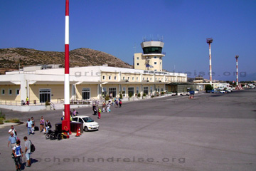 Flughafen Gebäude mit seinem Tower auf der Insel Samos. Passagiere laufen zum Flugzeug das zum Abflug nach Frankfurt am Main in Deutschland bereit steht.