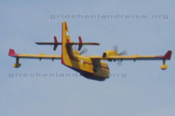Gelbes Wasserflugzeug im Einsatz bei einem Waldbrand auf einer griechischen Insel.